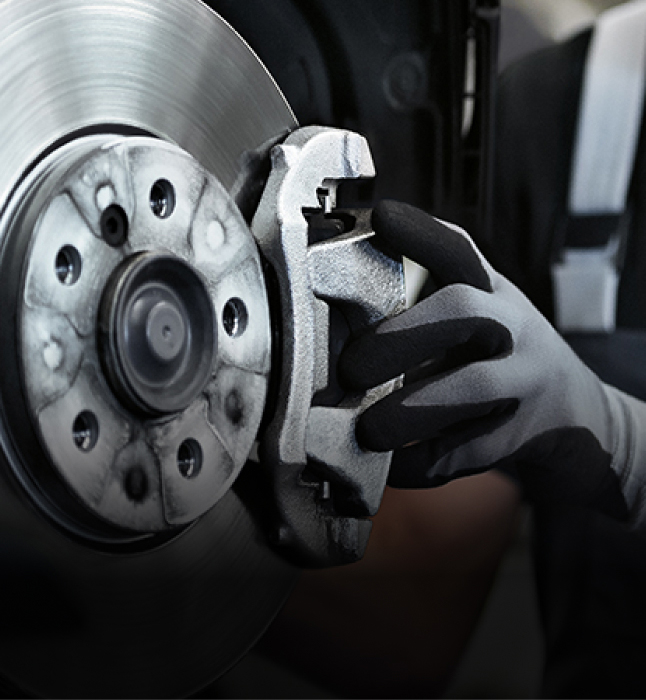 Close up of person adjusting a brake caliper