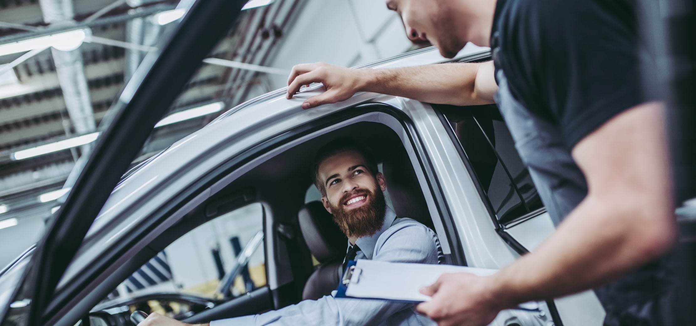 car owner bringing a vehicle in for service at a dealership