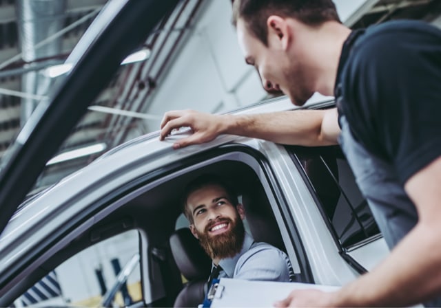 car owner bringing a vehicle in for service at a dealership